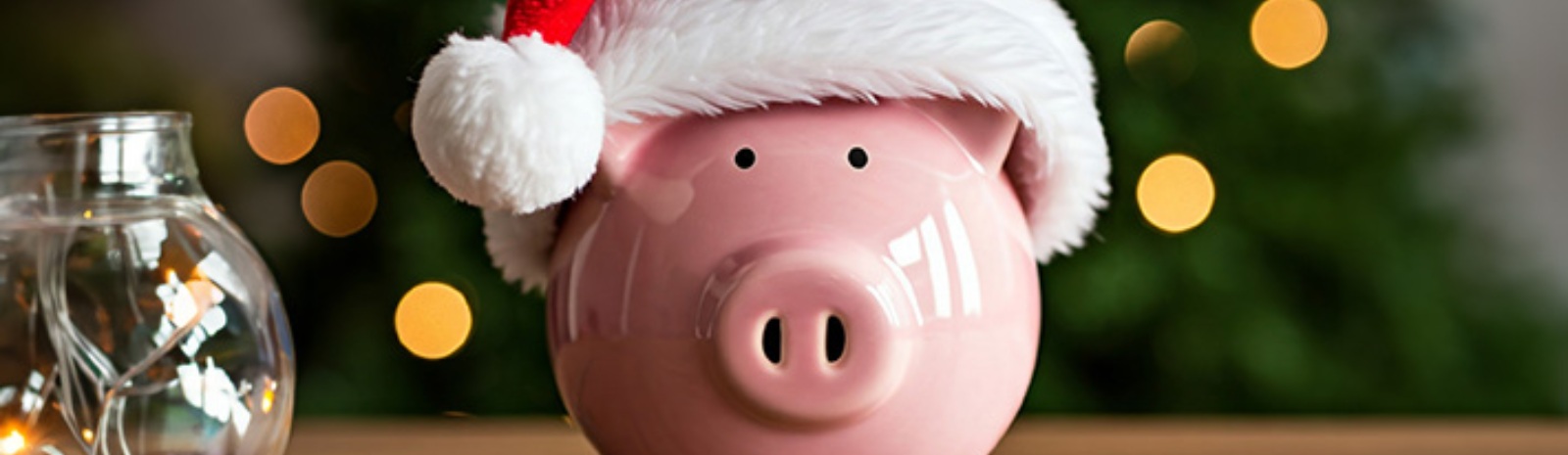 a pink piggy bank with a santa claus hat