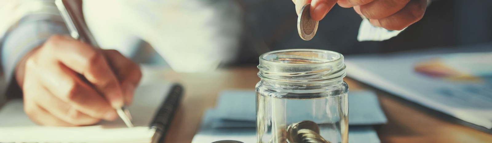 a business owner putting coins in a jar