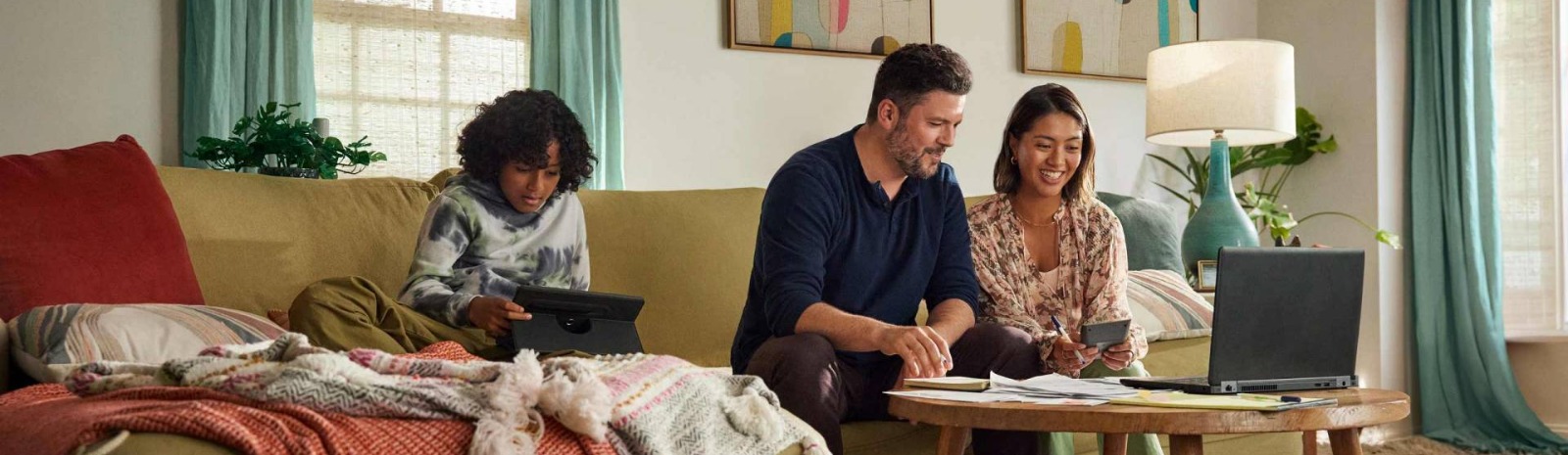 a family of three sitting on a couch